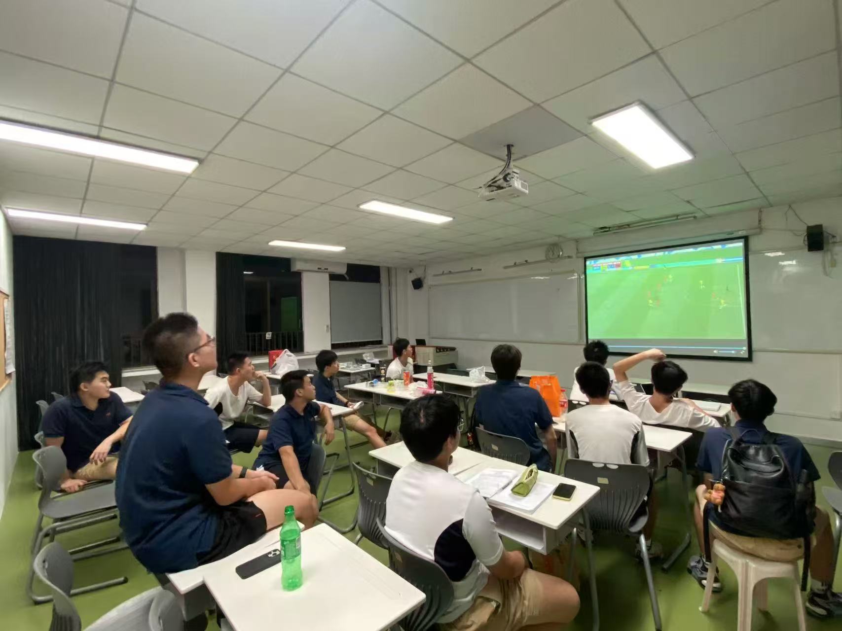 Watching a soccer match together in the classroom.